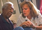 Hospice  RN case manager Jan Harvey, right, with Spartanburg Regional Hospice, says a prayer with patient William Garrett as she works with him in his home in Spartanburg Wednesday morning. Harvey sees her job as a calling, and goes beyond just the medical care with her patients.