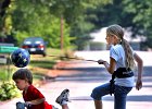 Kickball&#38;ScooterKids--FIN  Madeline Kiser, 9, kicks a soccer ball trainer as her brother Nathaniel Kiser, 3, rides his scooter in front of the family&#39;s home in Spartanburg Tuesday afternoon, 6-20-06. Madeline plays AYSO soccer and was working out with the ball trainer.  (NOTE: Stand-alone FEATURE) : PUBDATE_2006_06_24_HJ_B_2