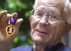 Veteran&#38;PurpleHeart.JPG  Floyd Lane, Sr., a WWII veteran, holds up one of his medals, the Purple Heart, in Spartanburg Monday. Although Lane is an Altzheimer&#39;s patient, he still remembers many experiences from the war.